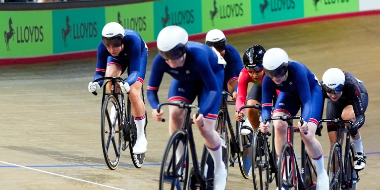 Cyclists racing indoors.