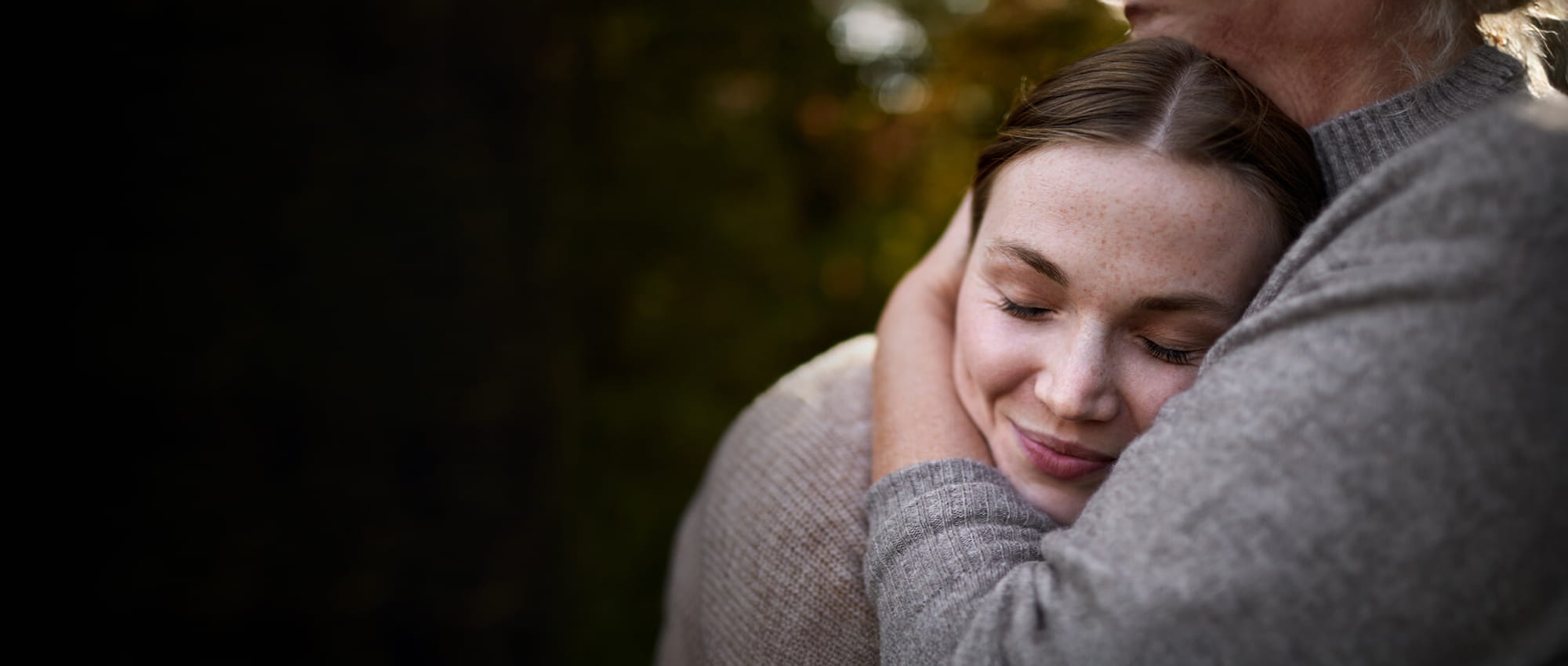 A woman being cuddled.