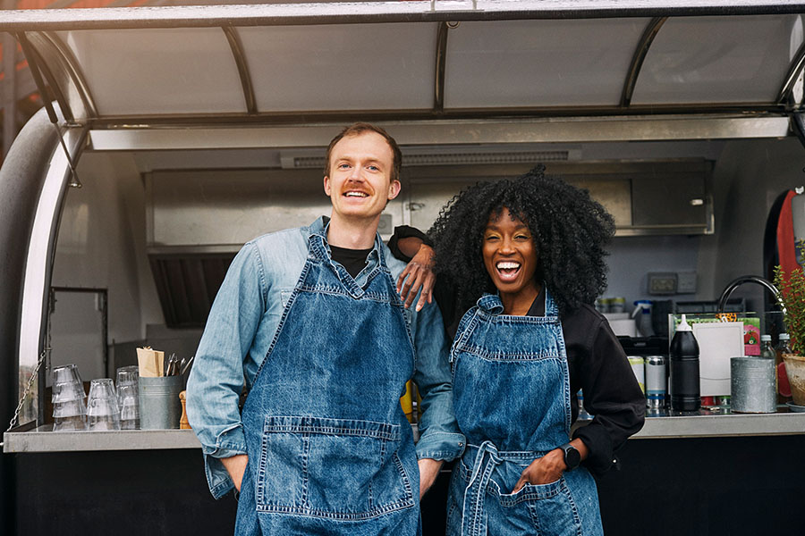 Two people discuss blueprints