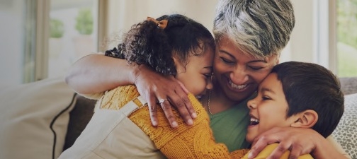 Woman hugging two children