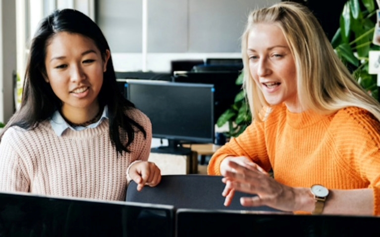 Two women looking at a screen