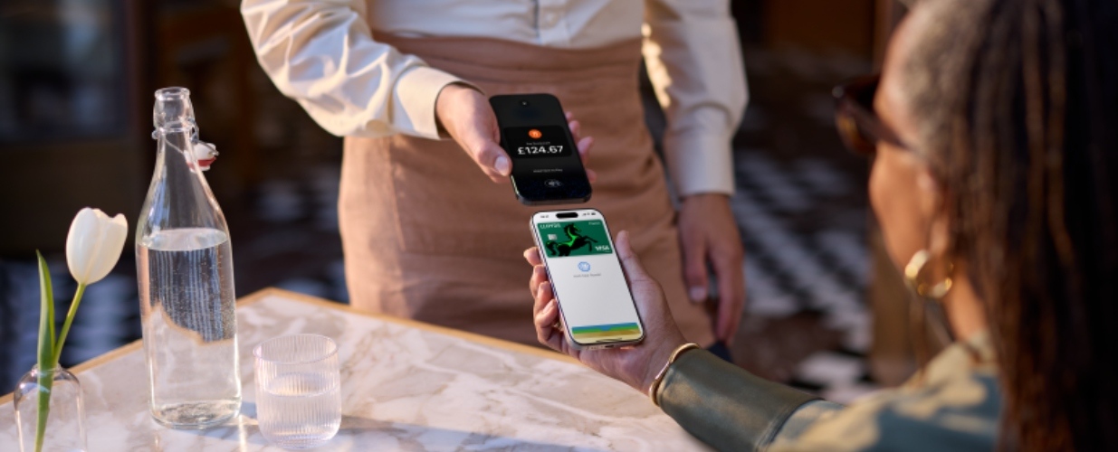 Person taking payment with Lloyds Accept using Tap to Pay.