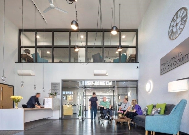 People gathered in the reception area of Saxon Court.