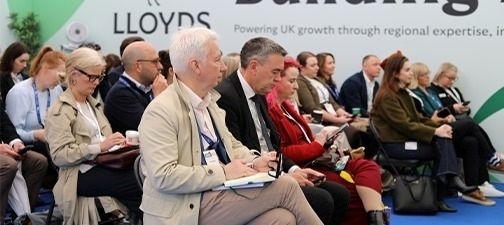 Audience members attending a Lloyds panel session at UKREiiF 2026 inside the Building Futures.
