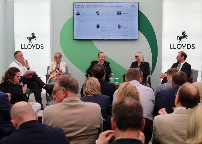Panel discussion on universities and innovation infrastructure hosted at the Lloyds Building Futures pavilion during UKREiiF 2026.