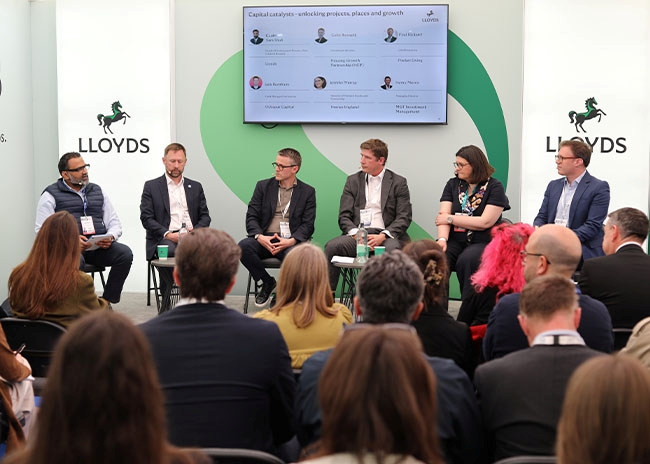 Industry leaders participating in a panel session on investment and growth at the Lloyds Building Futures pavilion during UKREiiF 2026.