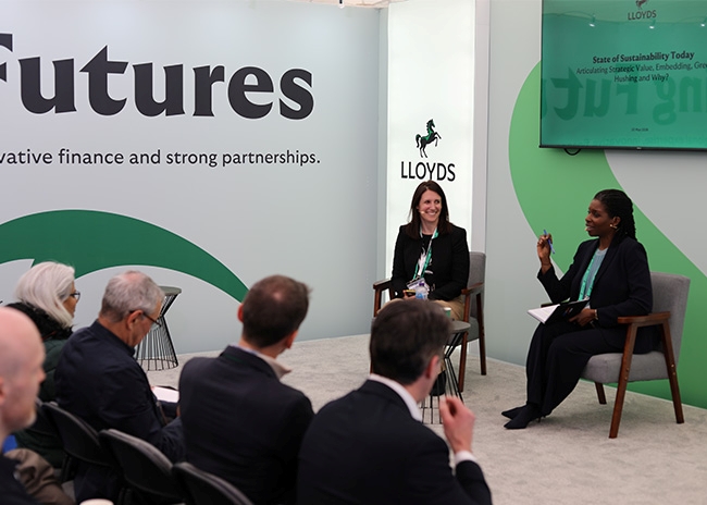 Speakers in conversation during a sustainability-focused discussion at the Lloyds Building Futures pavilion at UKREiiF 2026.