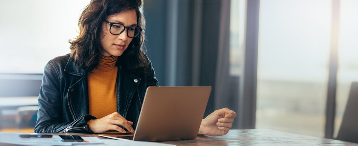 Asian business woman working on a laptop in a professional office