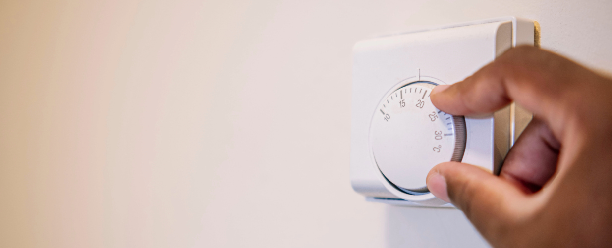 thermostat being turned