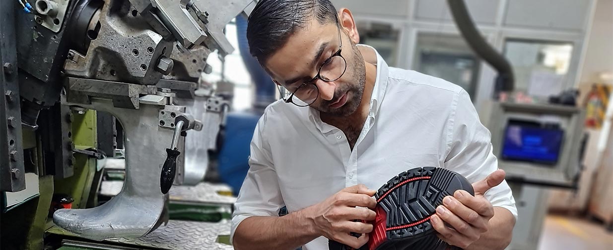 Man in boot factory

