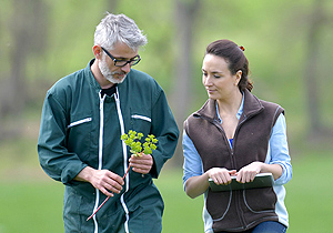 Two agriculture clients looking at produce on their farm