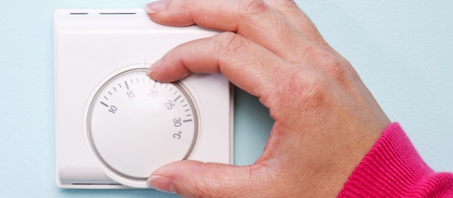 thermostat wheel being turned