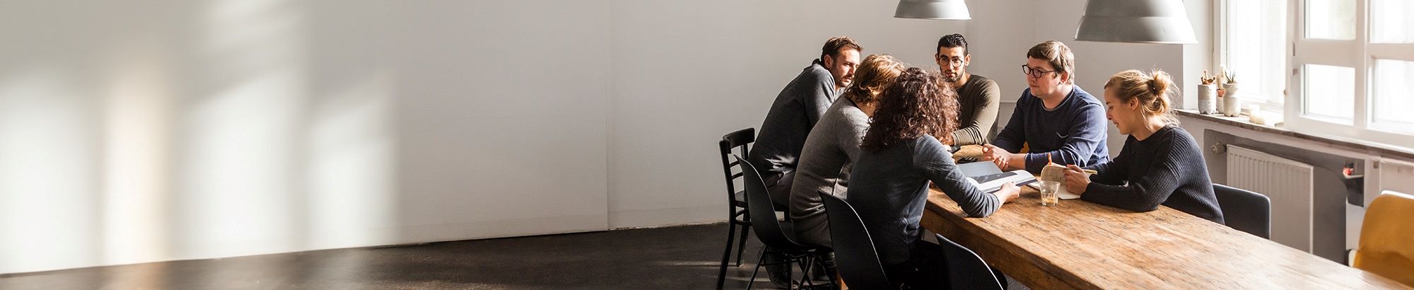 A group of people sat around a conference table