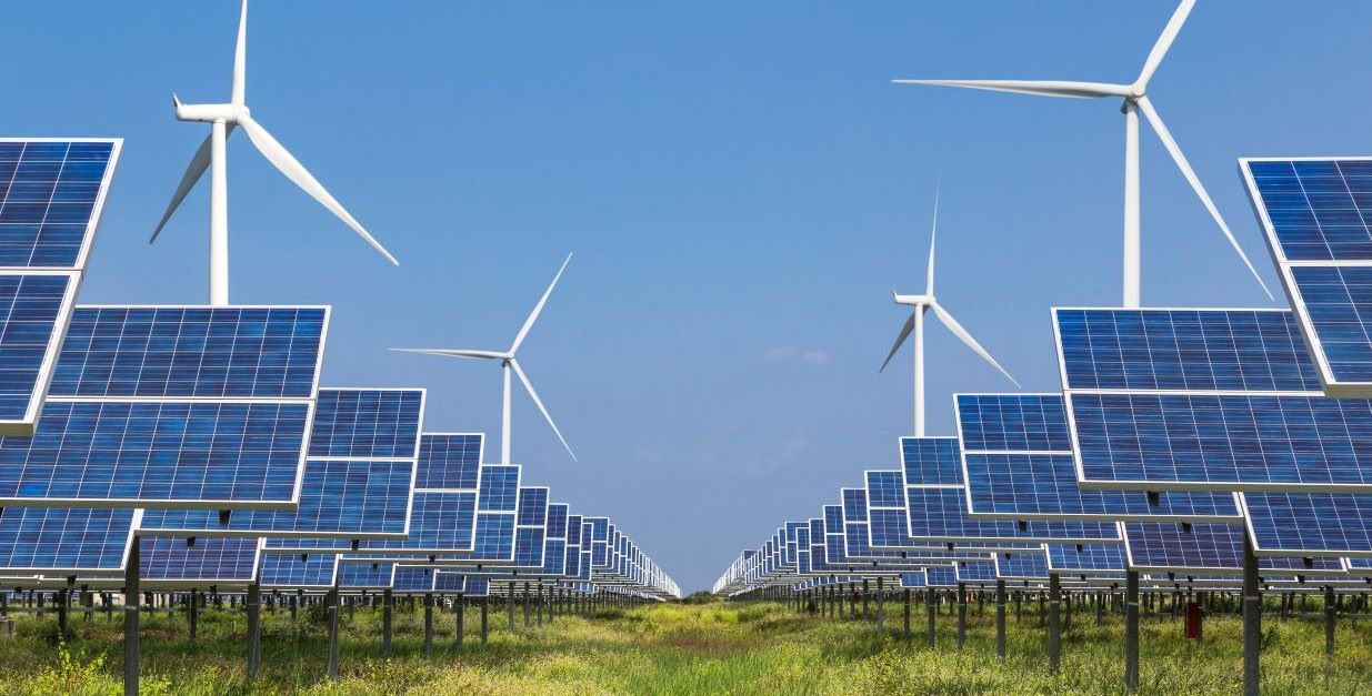 Solar panels & wind turbines in field