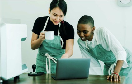 Business owners taking payments on a laptop