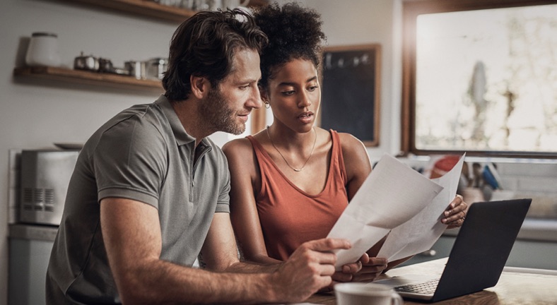 Couple reviewing paper bills