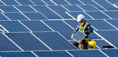 Two workers fixing solar panels