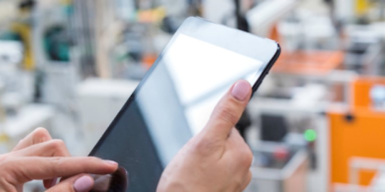 Person using a tablet in a factory