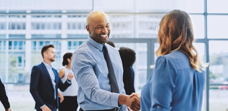 Business woman shaking hands with business man