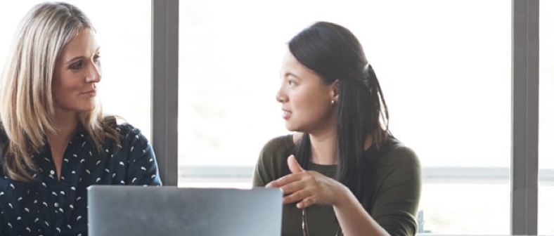 People working together around laptop