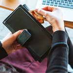 hand taking a card from a purse
