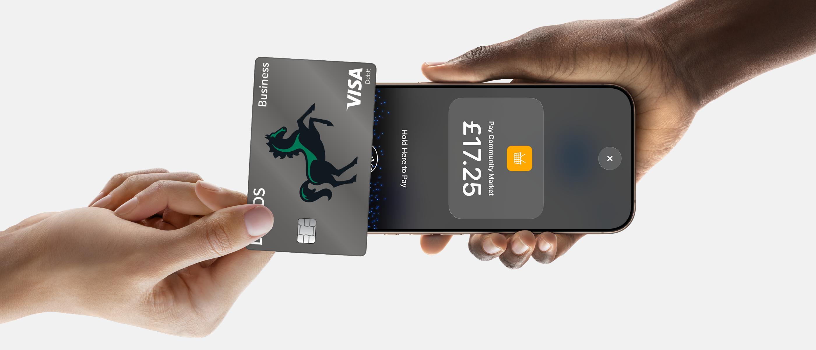 Person accepting contactless payment on iPhone with Lloyds Accept.