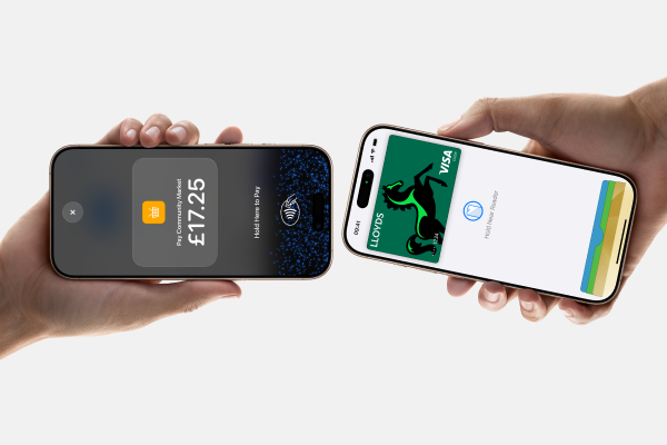 Person accepting contactless payment on iPhone with Lloyds Accept.