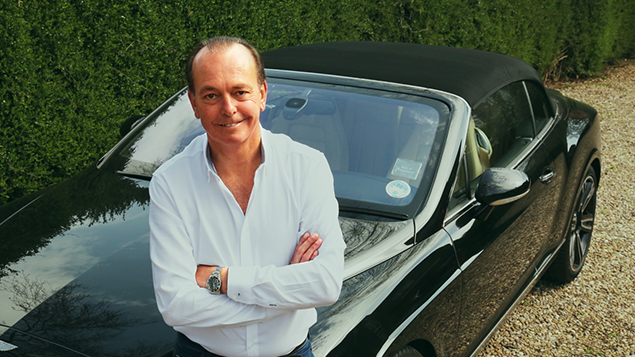 Quentin Wilson sat on the bonnet of a black car
