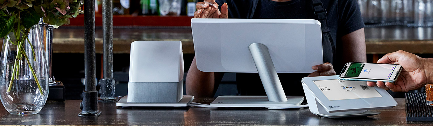 Waiter taking a payment using a Cardnet card machine