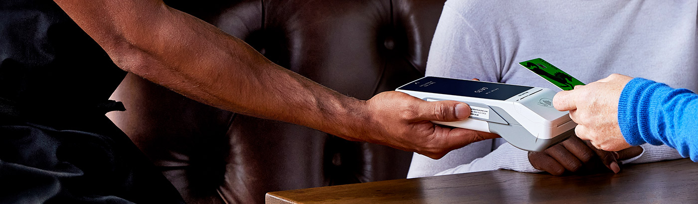 Waiter taking a payment using a Cardnet card machine