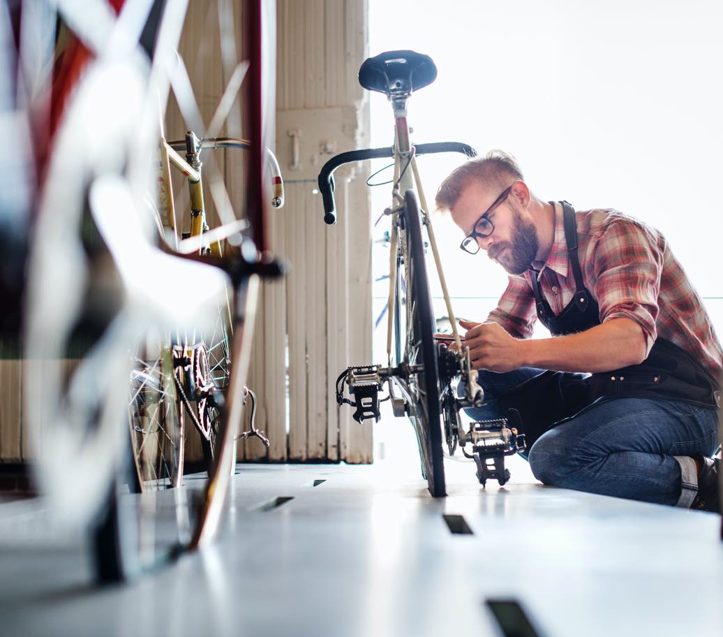 Person fixing a bike at a bicycle repair shop