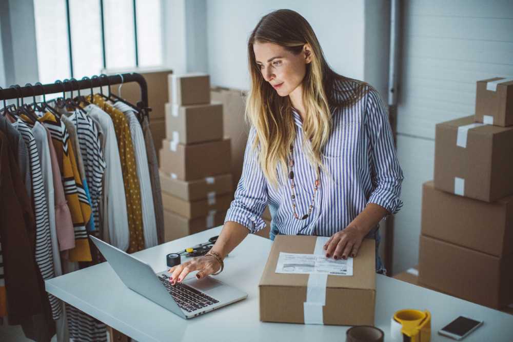 Image of business owner with a laptop sending an order