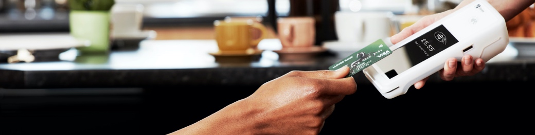 Waitress taking a payment with a Clover Flex portable card machine
