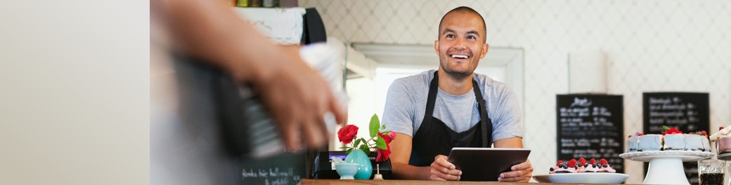Café owner taking payments online.
