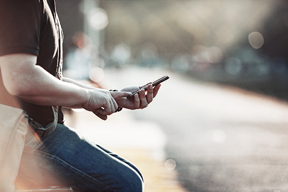 Man looking at mobile phone.