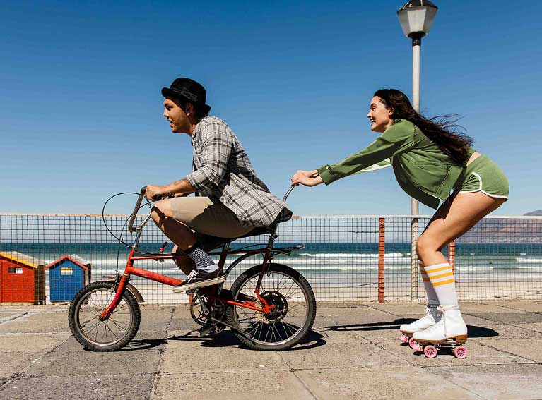 Two people on bike and roller skates