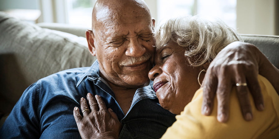 An old couple embrace