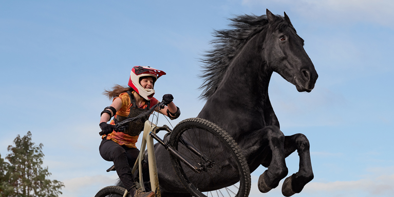 Person on a bike and a horse