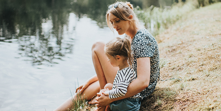 Woman and girl next to water