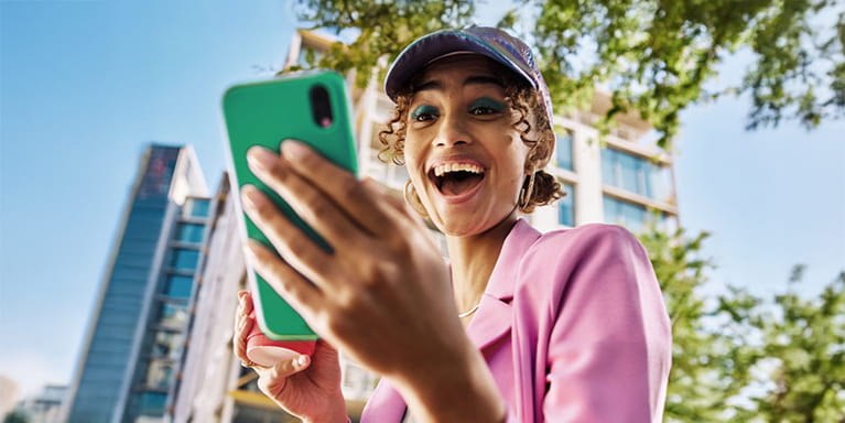 smiling woman holding a phone