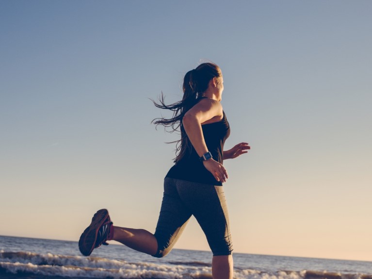 A young woman out running at dawn. 