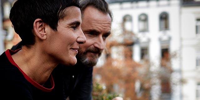 Two people looking out