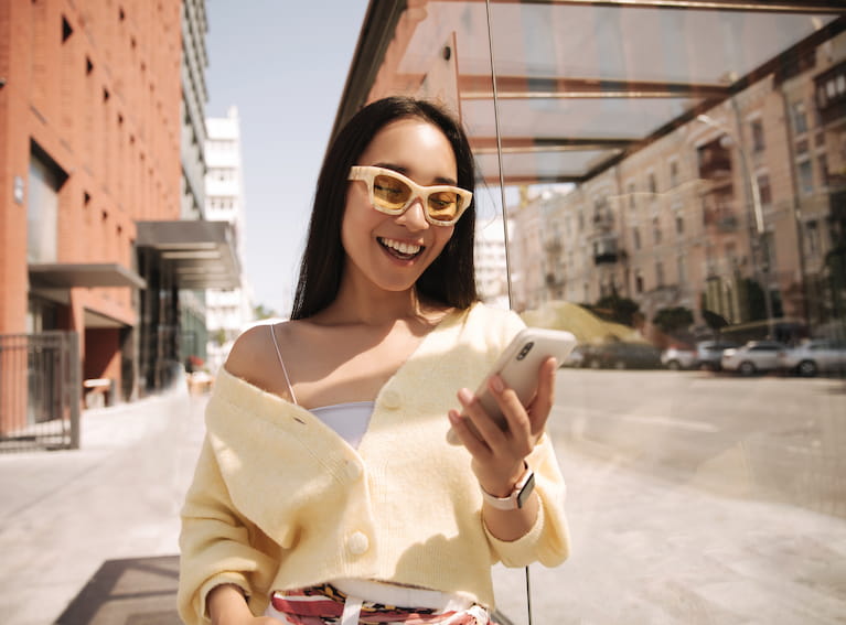 woman walking and using a mobile