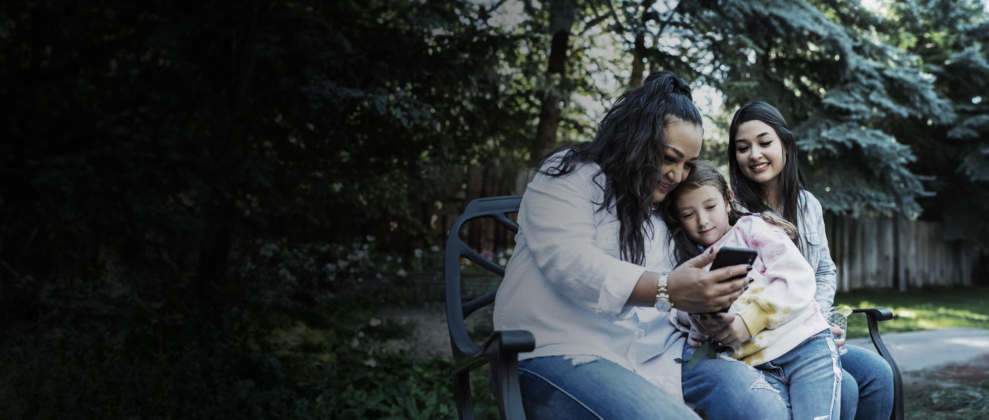 Women with children looking at mobile phone
