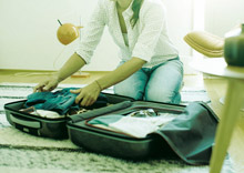 Women packing dress in suitcase