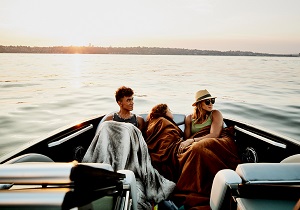Three people in a boat on holiday