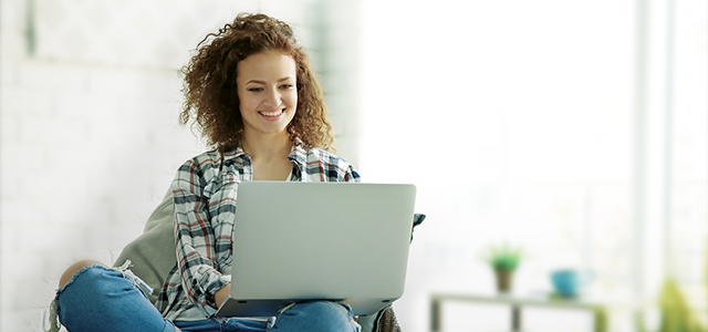 person sat looking at laptop