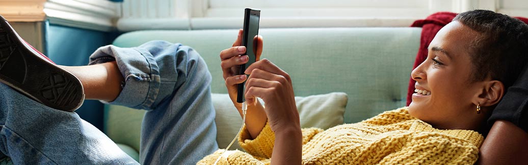 Person smiling at their phone