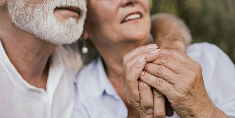 Older couple cuddling.