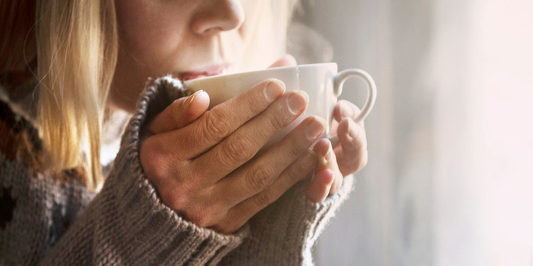 Woman drinking coffee.